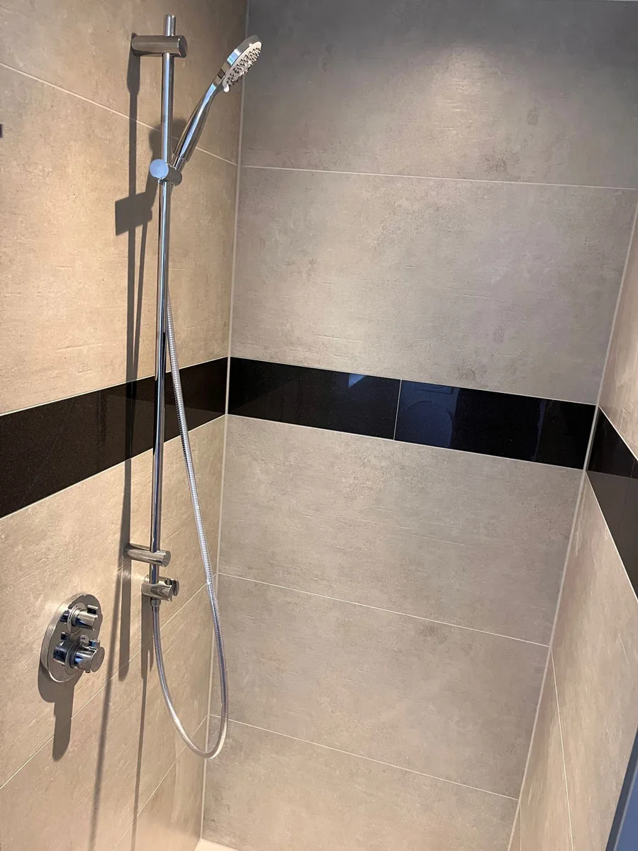 Detailaufnahme der Duscharmatur im sanierten Bad